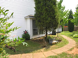 lovely backyard with wooded setting, landscaped garden and large storage shed.