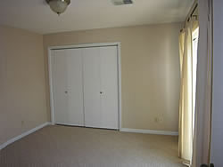 back bedroom with sliding door that leads to the patio